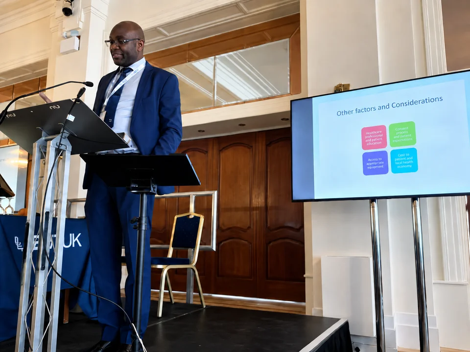 Mr Eugene Omakobia speaking at a lectern during an ENT meeting